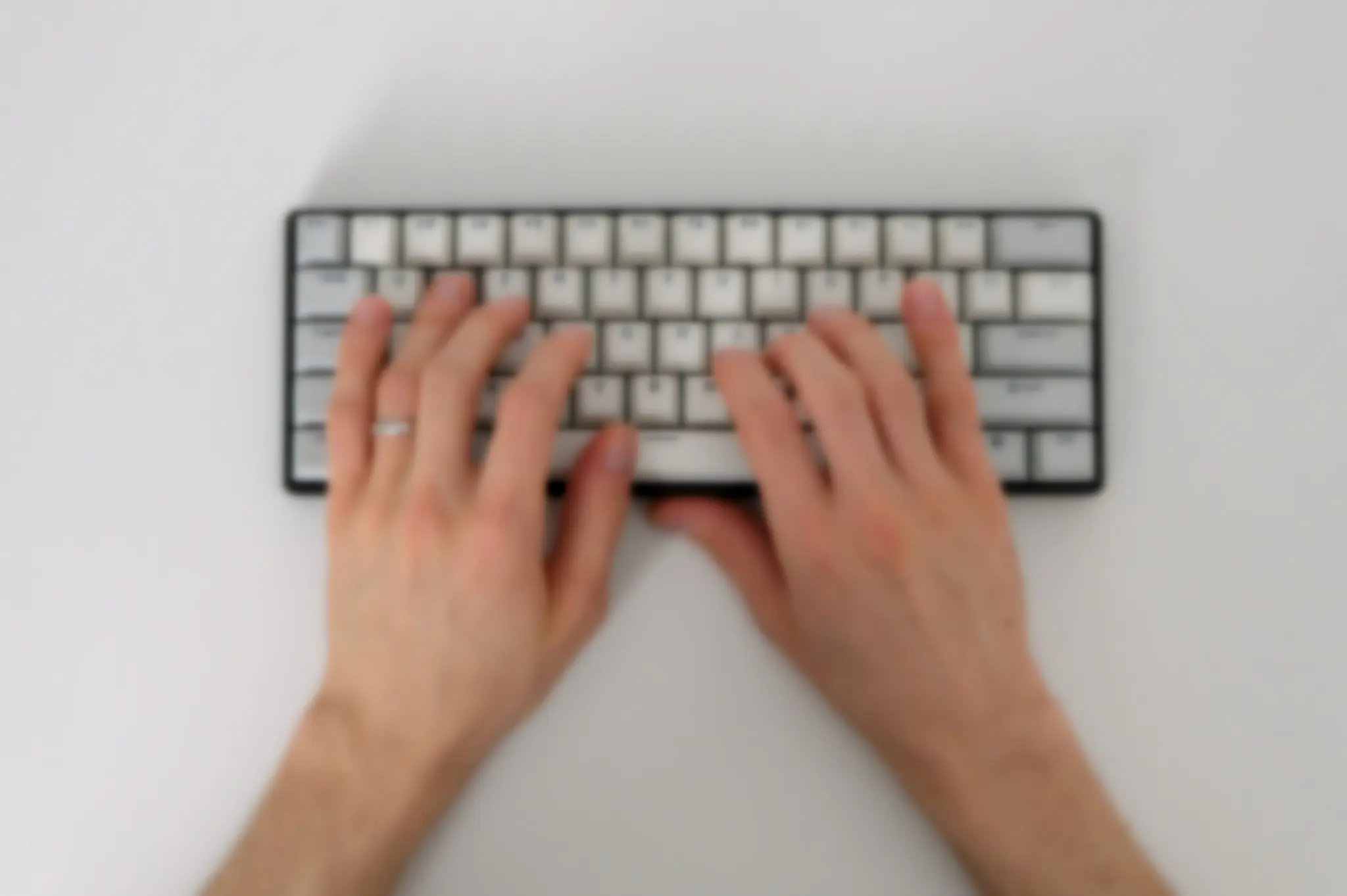 Background with hands typing on keyboard